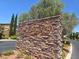 Community monument sign with stone accents and lush landscaping at 11298 Corsica Mist Ave, Las Vegas, NV 89135