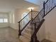 Staircase with wrought iron railing that leads to the upper level at 11298 Corsica Mist Ave, Las Vegas, NV 89135