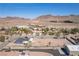 Scenic aerial view of property highlighting the mountains in the distance and neighborhood in the desert landscape at 1227 San Gabriel Ave, Henderson, NV 89002
