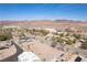 Wide aerial view of a neighborhood with desert landscaping and mountain backdrop on a clear day at 1227 San Gabriel Ave, Henderson, NV 89002