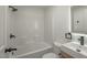 Contemporary bathroom featuring a sleek vanity, illuminated mirror, and shower-tub combo with white subway tile at 1227 San Gabriel Ave, Henderson, NV 89002