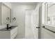 Well-lit bathroom featuring a modern vanity, mirror, and doorway leading to another room at 1227 San Gabriel Ave, Henderson, NV 89002