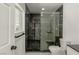 Modern bathroom with glass shower, black marble tile, and sleek fixtures at 1227 San Gabriel Ave, Henderson, NV 89002