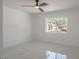 Bright bedroom featuring a ceiling fan, marble floors, and a large window letting in natural light at 1227 San Gabriel Ave, Henderson, NV 89002