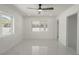 Bright bedroom with two large windows, modern ceiling fan, and white marble flooring at 1227 San Gabriel Ave, Henderson, NV 89002