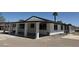 Side view of white home with black trim, many windows and large, covered patio space at 1227 San Gabriel Ave, Henderson, NV 89002