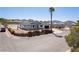 Charming single-story home featuring a desert landscape, palm tree, and black trimmed windows at 1227 San Gabriel Ave, Henderson, NV 89002