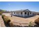Exterior view of a home with covered porch, modern trim, and desert landscaping at 1227 San Gabriel Ave, Henderson, NV 89002