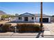 Front exterior showcases a charming single-story home with white pillars and black trim at 1227 San Gabriel Ave, Henderson, NV 89002
