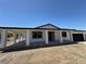 Single story house with white exterior, dark trim, attached garage and an elongated covered patio area at 1227 San Gabriel Ave, Henderson, NV 89002