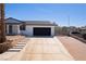 Exterior view of a home, black garage door, and extra parking for multiple vehicles at 1227 San Gabriel Ave, Henderson, NV 89002