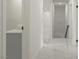Bright hallway featuring white marble floors and white walls with modern gray cabinets at 1227 San Gabriel Ave, Henderson, NV 89002
