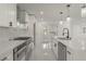 Contemporary kitchen boasting stainless appliances, white cabinetry, and marble countertops and backsplash at 1227 San Gabriel Ave, Henderson, NV 89002