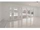 Bright living room with multiple sliding glass doors, white marble floors and backyard access at 1227 San Gabriel Ave, Henderson, NV 89002