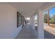 Side walkway featuring symmetrical columns and dark framed windows at 1227 San Gabriel Ave, Henderson, NV 89002