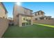 Exterior back of home with a small outdoor patio area featuring artificial turf at 12525 Lylan Ridge St, Las Vegas, NV 89138
