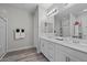 Bright bathroom with double vanity, modern lighting, and grey-toned flooring at 12525 Lylan Ridge St, Las Vegas, NV 89138