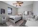 Charming bedroom with a ceiling fan, desk, and ample natural light at 12525 Lylan Ridge St, Las Vegas, NV 89138