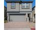 Charming two-story home featuring a gray exterior, garage, and a paved driveway at 12525 Lylan Ridge St, Las Vegas, NV 89138
