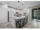 Modern kitchen with an island, stainless appliances, and sliding glass doors at 12525 Lylan Ridge St, Las Vegas, NV 89138
