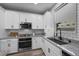 Close-up of the kitchen, showcasing granite countertops, stainless appliances and subway tile at 12525 Lylan Ridge St, Las Vegas, NV 89138
