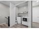 Convenient laundry room with washer, dryer, and storage shelving at 12525 Lylan Ridge St, Las Vegas, NV 89138
