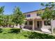 A spacious backyard featuring a covered patio, lush green lawn, and mature trees, perfect for outdoor relaxation at 1371 Cumulus Ct, Henderson, NV 89014