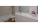 Bathroom with tub, white vanity, and a decorative flower arrangement at 1371 Cumulus Ct, Henderson, NV 89014