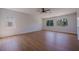 Large bedroom with light wood floors, fan and bright windows at 1371 Cumulus Ct, Henderson, NV 89014