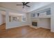Open living room with wood floors, recessed lighting, fireplace, and connected to the kitchen at 1371 Cumulus Ct, Henderson, NV 89014