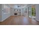 Bright living room featuring wood floors, a fireplace, and sliding doors to the backyard at 1371 Cumulus Ct, Henderson, NV 89014