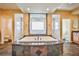 Luxurious bathroom with a large soaking tub, and vanities, and plenty of natural light at 1737 Cypress Manor Dr, Henderson, NV 89012