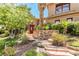 Beautifully landscaped front yard with stone steps leading to the home, offering a grand entrance at 1737 Cypress Manor Dr, Henderson, NV 89012