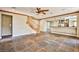 Spacious living room featuring slate floors, wooden trim, a ceiling fan, and an open concept kitchen at 1737 Cypress Manor Dr, Henderson, NV 89012