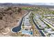 An aerial view shows homes with swimming pools nestled near a golf course and mountainous landscape at 175 Strada Fontana, Henderson, NV 89011