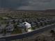 Gorgeous aerial view of a home with solar panels in a planned community near mountains on an overcast day at 175 Strada Fontana, Henderson, NV 89011