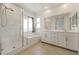 Bright bathroom featuring double sinks, a walk-in shower, and a soaking tub at 175 Strada Fontana, Henderson, NV 89011