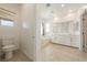 Bright bathroom featuring double sinks, a walk-in shower, and a soaking tub at 175 Strada Fontana, Henderson, NV 89011