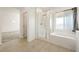 Bright bathroom featuring double sinks, a walk-in shower, and a soaking tub at 175 Strada Fontana, Henderson, NV 89011