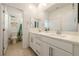 Bright bathroom featuring dual sinks, generous counter space, and tile flooring at 175 Strada Fontana, Henderson, NV 89011