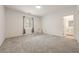 Light-filled bedroom featuring neutral walls, soft carpeting, and an attached bathroom at 175 Strada Fontana, Henderson, NV 89011