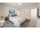Comfortable bedroom features neutral tones, soft carpet, and stylish furnishings with ensuite access at 175 Strada Fontana, Henderson, NV 89011