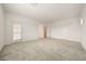 Large bedroom with neutral carpet, and doors leading to the closet and hall, plus a window with natural light at 175 Strada Fontana, Henderson, NV 89011