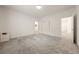 A spacious bedroom featuring neutral walls, plush carpet, closet, and ensuite bathroom access at 175 Strada Fontana, Henderson, NV 89011