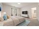 Bright bedroom enhanced with neutral walls, carpeting, and thoughtfully placed decor for inviting ambiance at 175 Strada Fontana, Henderson, NV 89011