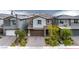 A charming two-story home with a neat front yard featuring desert landscaping and a paved driveway at 175 Strada Fontana, Henderson, NV 89011
