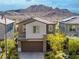 Charming two-story home with a desert landscaped front yard and attached garage, set against a mountain backdrop at 175 Strada Fontana, Henderson, NV 89011