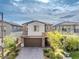 Inviting front exterior of a two-story home featuring a paved driveway, attached garage, and desert landscaping at 175 Strada Fontana, Henderson, NV 89011