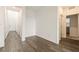 Empty hallway with wood flooring, white walls, and multiple doors leading to various rooms at 175 Strada Fontana, Henderson, NV 89011