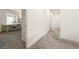 Bright hallway featuring neutral walls, plush carpeting, and a view into a well-lit office space at 175 Strada Fontana, Henderson, NV 89011